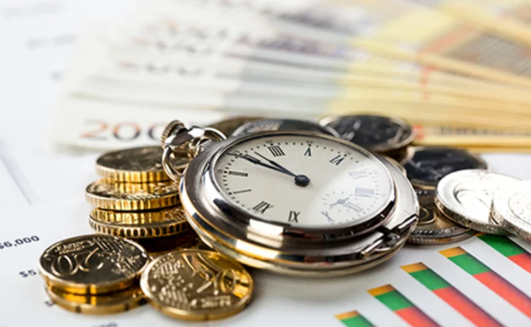 Photo of a pocket watch and coins on euro notes